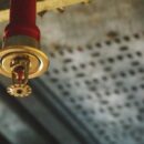 Fire sprinkler head mounted on ceiling as part of an automatic fire suppression system