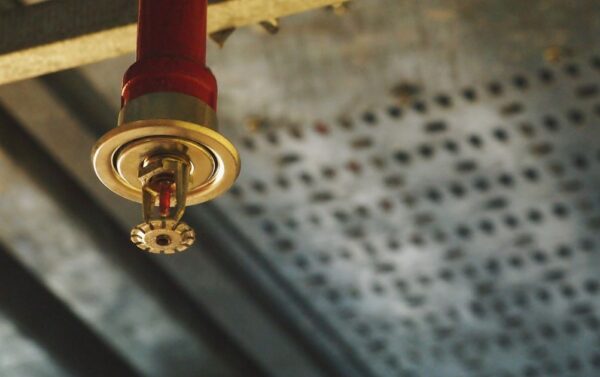 Fire sprinkler head mounted on ceiling as part of an automatic fire suppression system